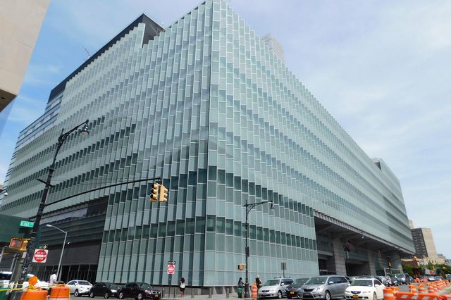 A photograph of the Bronx Hall of Justice, a modern green glass building